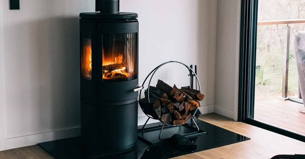 How to Get Rid of Bugs in Firewood - a log burner with a basket stacked of firewood next to it within a home